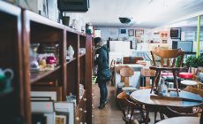 woman standing beside shelf