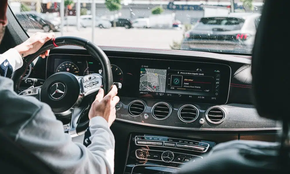 person in gray long sleeve shirt driving car