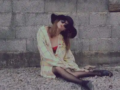 woman leaning on wall while sitting on floor